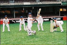Children playing a modified cricket game